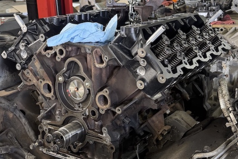 V8 diesel engine out of the truck on the shop floor with the heads exposed.